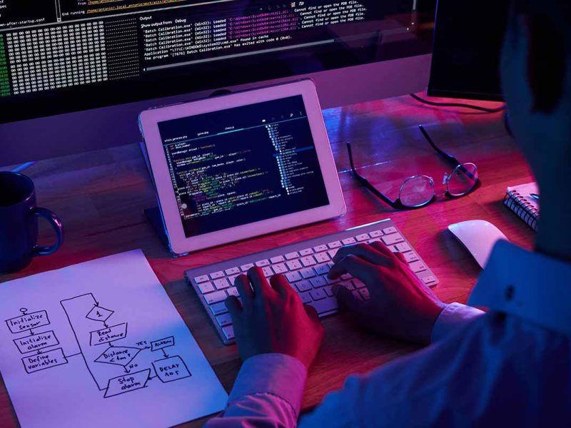 Programmer working at IT company office late at night